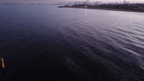 Swimming-On-Sunrise-Over-Melbourne-Drone-Pan-Up