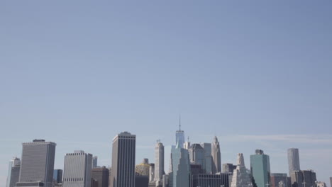 Downtown-Skyline-Cityscape-Against-a-Light-Blue-Sky,-Lower-Manhattan,-One-World-Trade-Center-Freedom-Tower