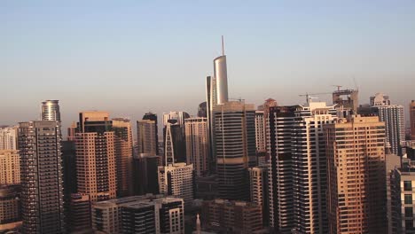 Time-Lapse-sunset-in-Dubai-skyscrapers,-Burj-Khalifa-at-the-background,-clear-sky,-static-shot
