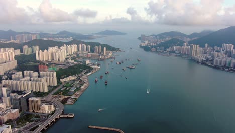 Hong-Kong-marina-with-anchored-boats-and-Kwun-Tong-area-buildings,-Aerial-view