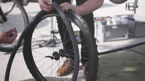 A-bike-wheel-being-equiped-with-a-new-tube-by-a-bike-mechanic