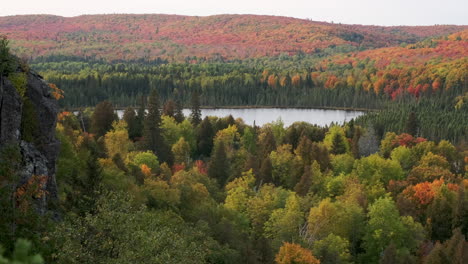 Slow-Pan-Of-Remote-Lake-Surrounded-By-Fall-Foliage