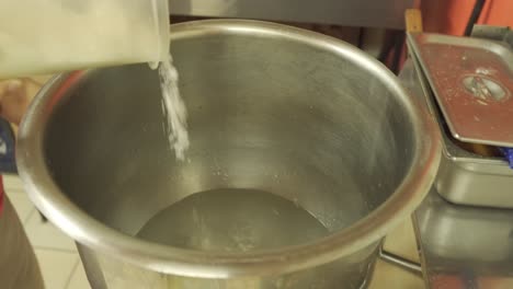 Salt-Being-Poured-into-Large-Mixing-Bowl