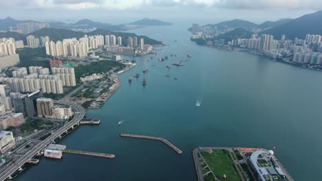 Hong-Kong-marina-with-anchored-boats-and-Kwun-Tong-area-buildings,-Aerial-view