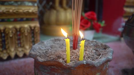 120-speed-footage-of-yellow-candles-burning-at-a-temple-to-light-incense-for-guiding-meditation