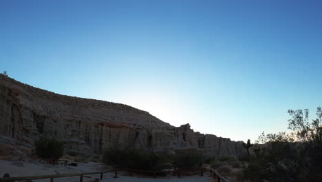 The-cliffs-at-RedRock-Canyon-State-Park-a-dusk---panoramic-sliding-view-as-seen-from-a-car-window