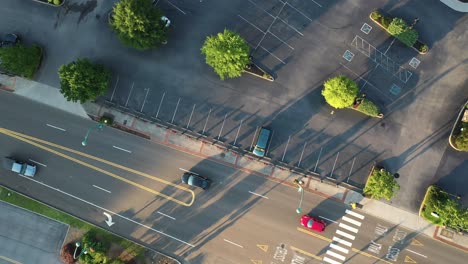 Top-Down-Aerial-View-of-Street-in-American-City-and-Van-on-Almost-Empty-Parking-Lot