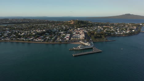 Aerial-View-Of-The-Victorian-Style-Seaside-Village-In-Devonport,-Auckland,-New-Zealand-Surrounded-By-Calm-Blue-Sea---drone-shot