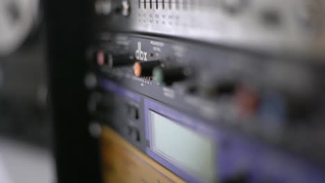 Close-up-of-audio-recording-device-with-knobs-and-switches