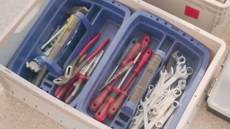 A-mechanic's-tool-box-with-wrenches,-srew-drivers-and-forceps