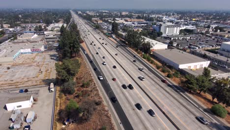 Aerial-view-overlooking-traffic-on-the-405-Freeway,-on-a-sunny-day,-In-Los-Angeles,-California,-USA---dolly,-drone-shot