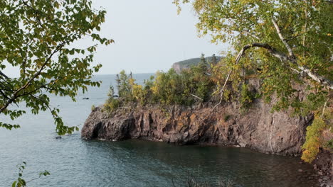 Looking-Through-Trees-At-A-Rocky-Lake-Superior-Peninsula