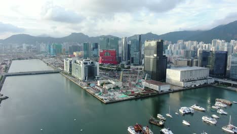 Hong-Kong-Kowloon-Bay-Area-with-city-skyscrapers-and-new-Children-hospital-building-during-construction,-Aerial-view