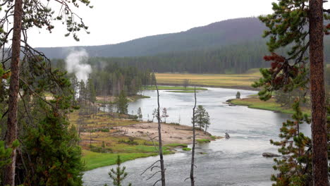 Landscape-in-Yellowstone-National-Park-with-Yellowstone-River,-mountains-and-geothermal-feature