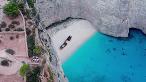 Tourists-Viewing-Shipwreck-From-Cliff