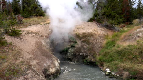 Long-shot-of-steam-cloud-rising-in-slow-motion-from-Dragon's-Mouth-Spring-in-Yellowstone-National-Park