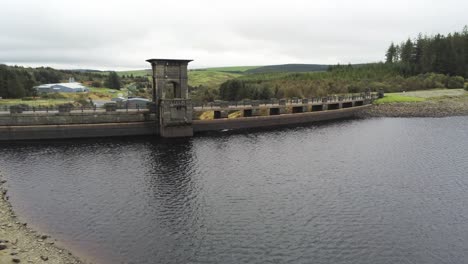 Alwen-reservoir-industrial-hydroelectric-landmark-historical-rural-lake-dam-building-aerial-orbit-left-push-in