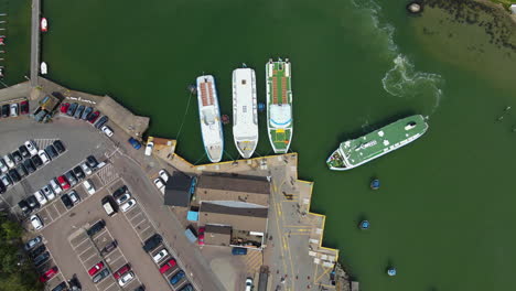 Passenger-Ferry-Boat-Arriving-At-The-Docking-Terminal-In-Saltholmen,-Gothenbrug,-Sweden---aerial-drone,-top-down-shot