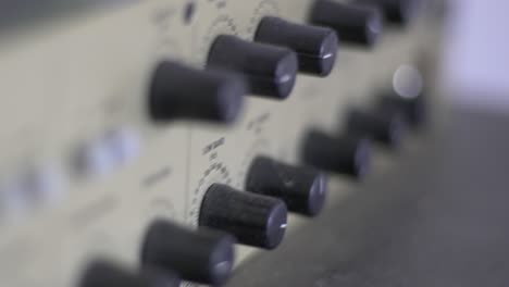 Close-up-of-knobs-and-switches-on-a-audio-recording-device