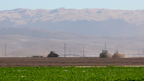 Tractors-plowing-field-in-Salinas,-CA