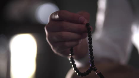 Hand-of-Muslim-man-making-zikr-using-rosary