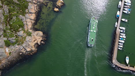 Aerial-View-Of-A-Ferry-Boat-Cruising-Over-The-Calm-Sea-In-Saltholmen,-Gothenburg,-Sweden---drone-shot
