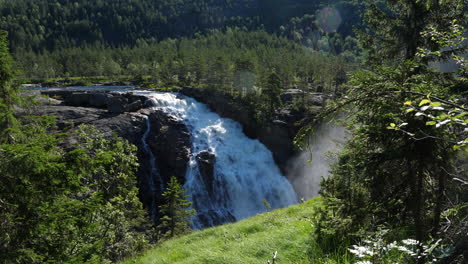 RjukanFossen-waterfall,-sunny,-summer-day,-in-Tinn,-Agder,-South-Norway---pan-shot
