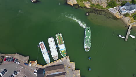 Arrival-Of-A-Sailing-Ferry-Boat-At-The-Pier-In-Saltholmen,-Gothenburg,-Sweden---aerial-drone
