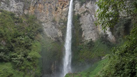 Slow-motion-shot-of-Sipiso-Piso-Waterfall-in-North-Sumatra,-Indonesia---camera-slowly-tilting-up