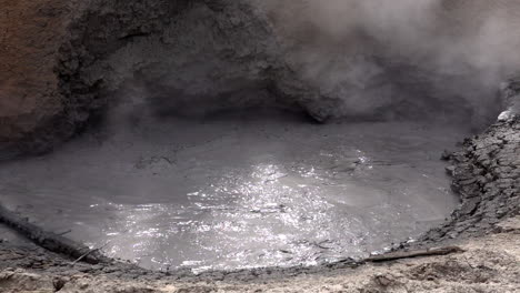 Turbulent-mud-and-steam-from-a-geothermal-mud-pot-in-slow-motion,-at-Yellowstone-National-Park