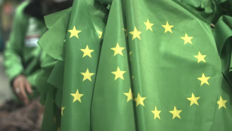 Close-up-of-a-bunch-of-green-eu-flags-at-a-demonstration-event