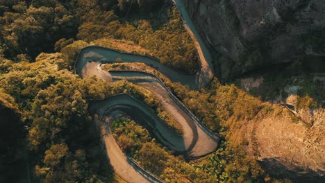 Top-down-aerial-view-of-one-of-the-most-beautiful-and-dangerous-roads-in-the-world-at-sunset,-Serra-Do-Corvo-Branco,-Urubici,-Santa-Catarina,-Brazil