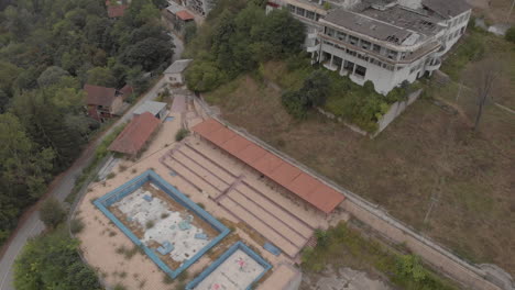 Abandoned-outdoor-pool-and-demolished-hotel-in-the-mountains
