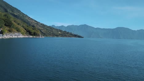 Drone-aerial-revealing-shot-of-the-beautiful-blue-lake-Atitlan-in-Guatemala