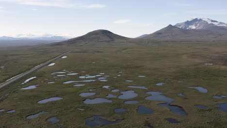 Aerial-of-Icelandic-marshland-on-flat-land-with-Snaefell-mountains-in-background