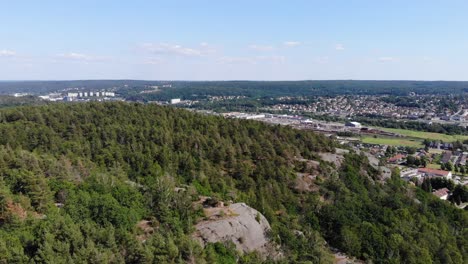 Aerial-view-of-evergreen-forest-outside-of-urban-area-of-Gothenburg