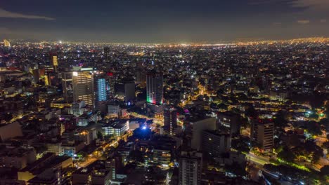 Mexico-City-at-Night-with-Independence-Day-Lights,-Aerial-Hyperlapse-Backward