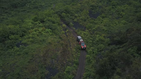 Drone-aerial-wide-landscape-shot-of-a-4x4-car-driving-off-road-during-extreme-expedition,-camping-trip-to-Pacaya-Volcano,-Guatemala