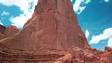Tilting-up-shot-of-a-giant-sandstone-rock-in-the-desert