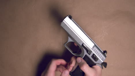 Hands-loading-9mm-pistol-with-magazine-and-getting-stuck