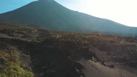 Drone-aerial-flying-over-the-rocky,-sandy-and-volcanic-landscape-in-Pacaya-Volcano,-Guatemala