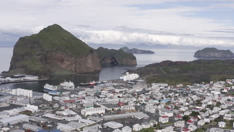 Aerial-of-small-town-Vestmannaeyjar-in-remote-archipelago-of-Iceland,-pan-right