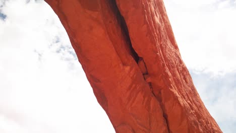 Kamerafahrt-Entlang-Der-Spannweite-Eines-Riesigen-Sandsteinbogens-Mit-Lens-Flare-Im-Arches-National-Park,-Utah