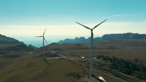 Drone-aerial-view-of-two-wind-turbine-generators-located-on-high-altitude-mountains