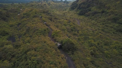 Drone-aerial,-cars-driving-off-road-on-the-forest,-extreme-expedition,-Pacaya-Volcano,-Guatemala