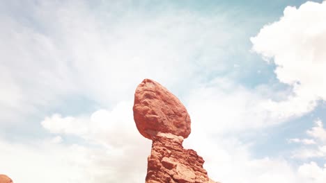 Tilting-down-shot-of-Balance-Rock-in-Arches-National-Park,-Utah