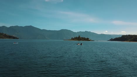 Amazing-drone-aerial-shot-of-Lake-Atitlan,-Guatemala---Local-fisherman-rowing-on-boats,-fishing,-kayaking
