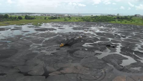 Wide-drone-view-of-Workers-Mining-on-The-Pitch-Lake-in-Trinidad