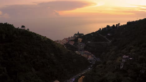 Aerial-drone-footage-close-to-the-area-of-Cinque-Terre-at-the-Mediterranean-seaside-coast-of-Italy-with-sunset-sky-at-the-iconic-villages-Monterosso,-Vernazza,-Corniglia,-Manarola-and-Riomaggiore