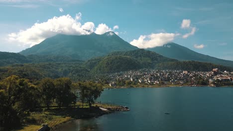 Drone-aerial-landscape-view-of-volcanoes,-mountains-and-Lake-atitlan,-Guatemala-during-a-sunny-day